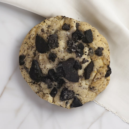 UniCookies Moo Moon, cookies n cream cookie with a peanut butter macaron baked in the center. Enlarged for detail.